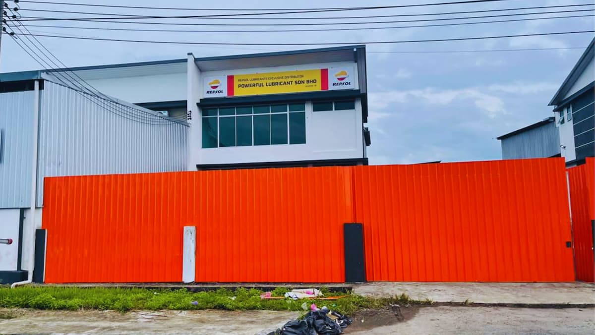 SIBU branch with multiple orange Repsol oil barrels and a warehouse.